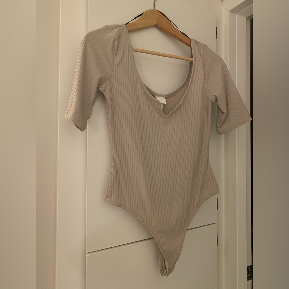 H&M beige Women’s mid sleeve length 65% recycled polyester body suit.